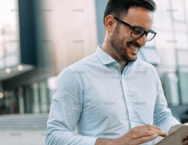 demo-attachment-609-portrait-of-businessman-in-glasses-holding-tablet-AWVHCJU